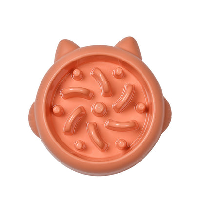 Orange slow feeder dog bowl with raised ridges and ears, designed to prevent gulping