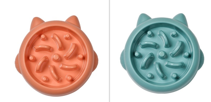 Orange and teal cat-shaped slow feeder bowls with raised paw and swirl designs for pet feeding