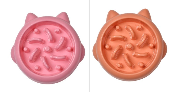 Pink and orange slow feeder cat bowls with raised paw-shaped designs to prevent gulping