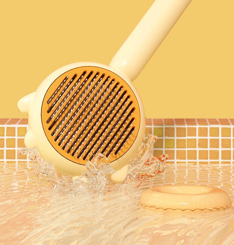 Yellow pet grooming brush with metal teeth splashing water on tiled surface with matching yellow background