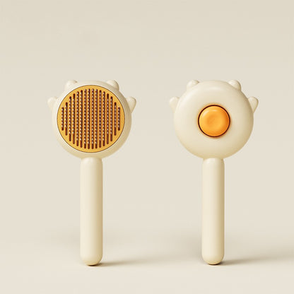 Cream and orange plastic pet grooming brush with fine metal bristles shown front and back