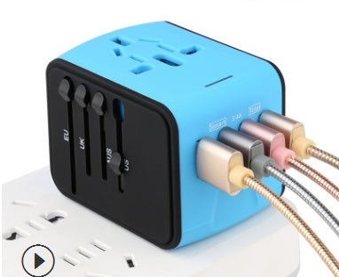 Blue universal travel adapter with USB ports plugged in, showing EU, UK, US, AU plug sliders
