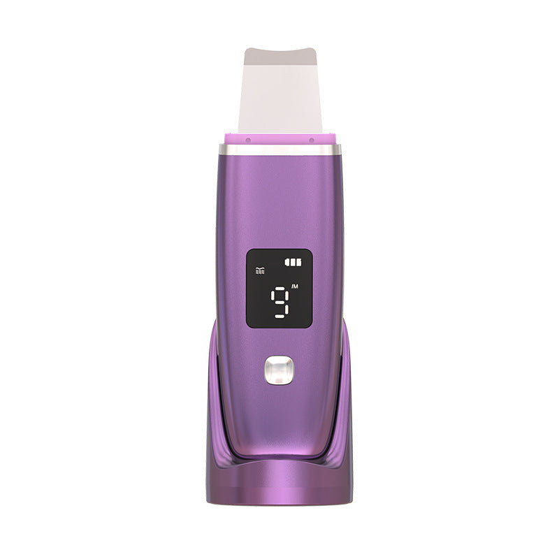 Purple ultrasonic blackhead remover with LED display on charging stand for deep pore cleansing