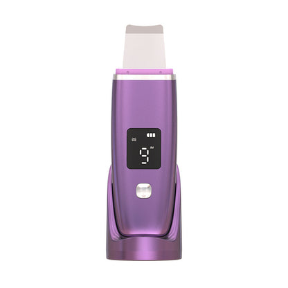 Purple ultrasonic blackhead remover with LED display on charging stand for deep pore cleansing
