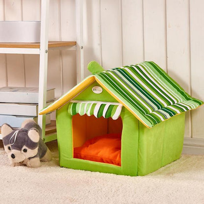 green striped folding pet house with removable cover and orange cushion on beige carpet