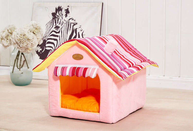 Pink and striped folding pet house with removable cushion on beige floor near white wall and zebra artwork