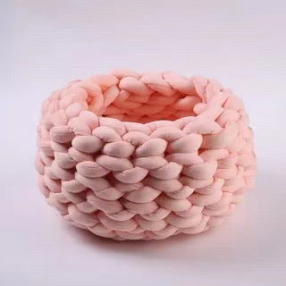 Soft pink chunky knit round pet bed with thick braided design, cozy and plush