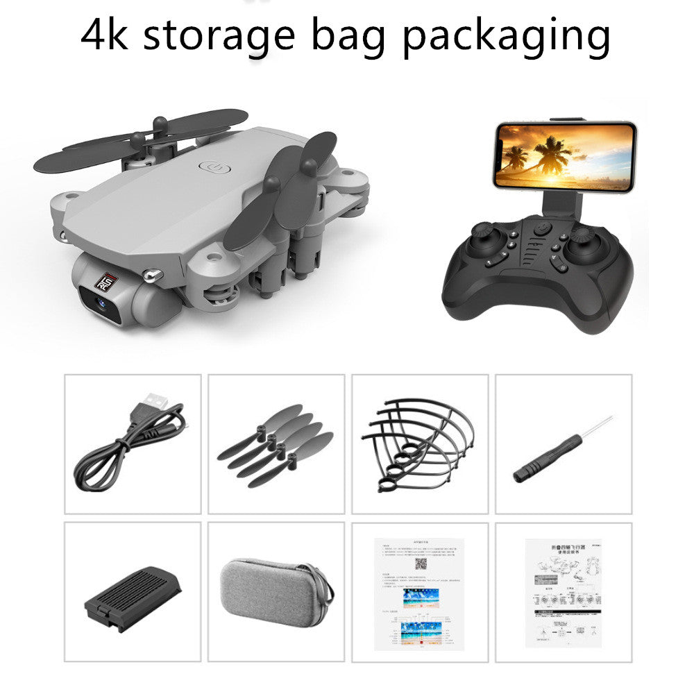 Compact grey folding mini drone with 4-axis propellers, remote with phone mount, USB cable, spare blades, propeller guards, screwdriver, battery, carrying case, and manuals