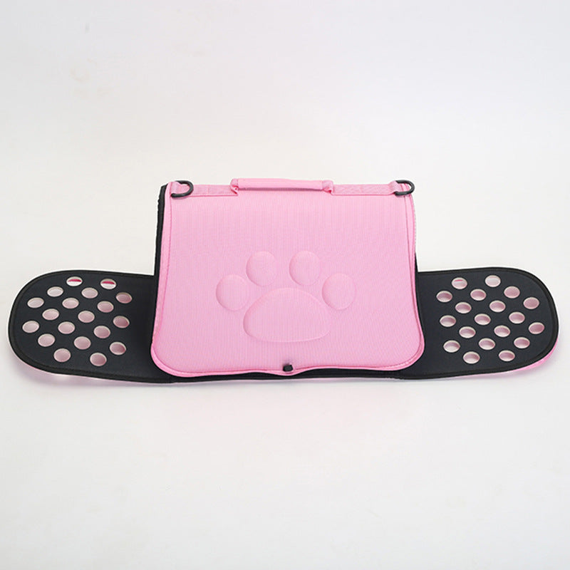 Pink foldable pet carrier with embossed paw print and black ventilated side panels