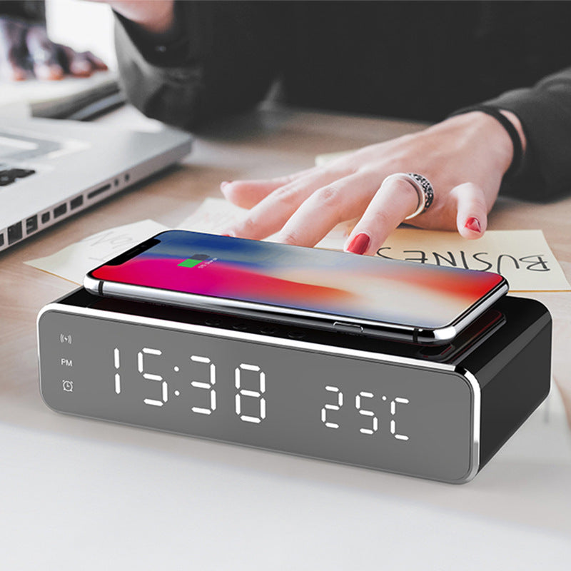 Grey LED digital alarm clock with wireless phone charger showing 15:38 and 25°C on display