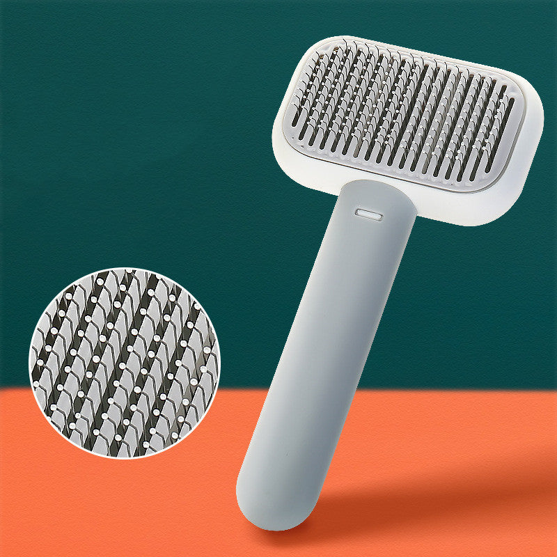 Ergonomic grey pet grooming brush with close-up of fine metal bristles for cat and dog shedding