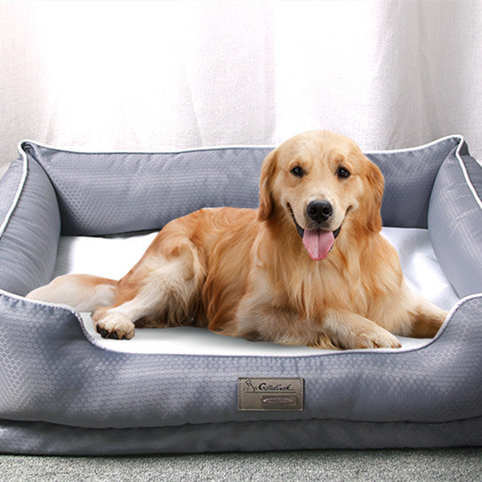 Golden retriever lying on a grey removable dog bed with machine washable cover indoors