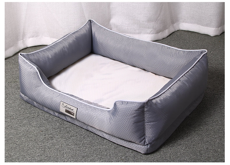 Grey removable dog bed with white inner cushion on grey carpet near white curtains