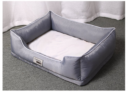 Grey removable dog bed with white inner cushion on grey carpet near white curtains