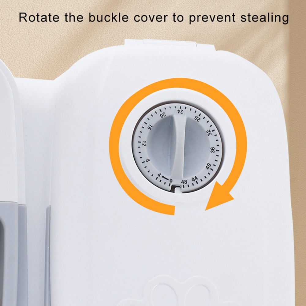 Close-up of white automatic pet feeder timer dial with orange rotation arrow and theft prevention text