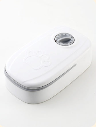 White automatic pet feeder with a paw print design and a timer dial on top, designed for scheduled feeding