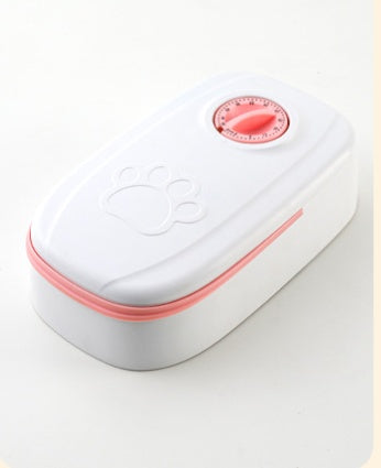 White and pink pet feeder with timer dial and paw print design on top