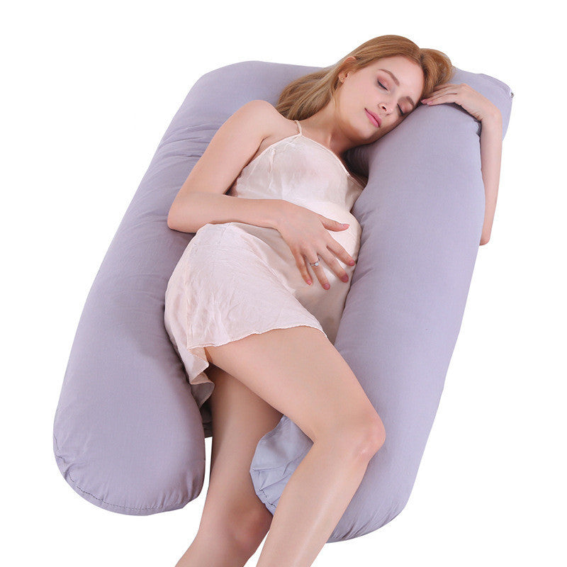 Pregnant woman resting on a grey U-shaped maternity pillow with ice silk pillow cover