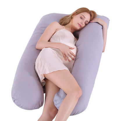 Pregnant woman resting on a grey U-shaped maternity pillow with ice silk pillow cover