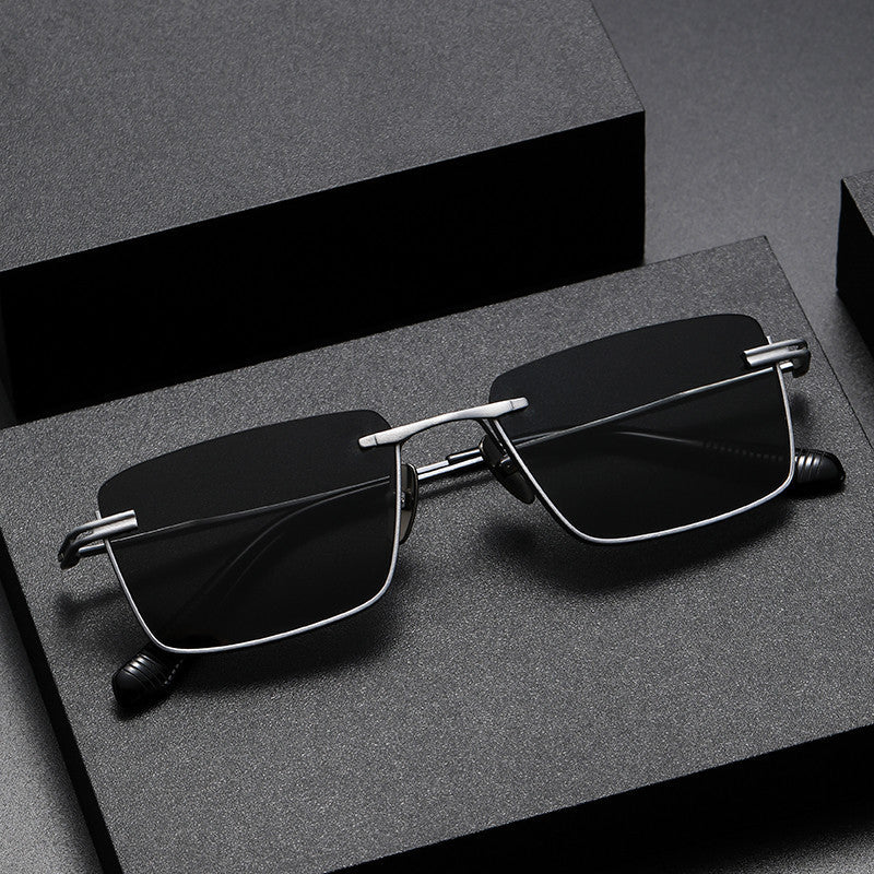 Black and gray polarized retro-style sunglasses with gunmetal frame on textured dark surface