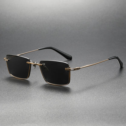 Black and gold rimless square polarized sunglasses on gray surface with retro style