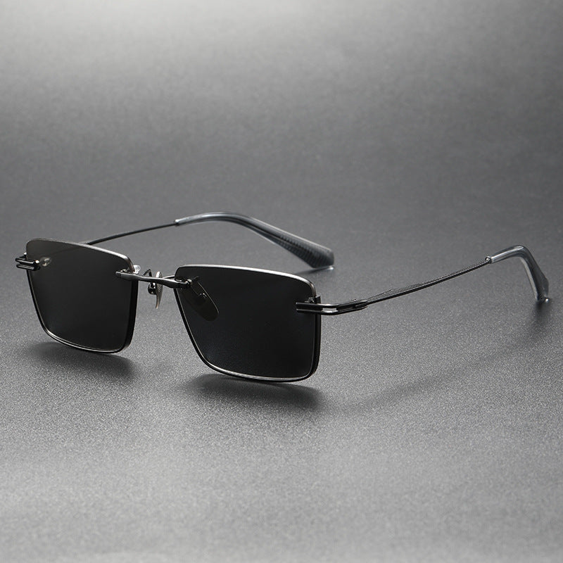 Black and gray rectangular polarized sunglasses with thin metal frame on gray surface