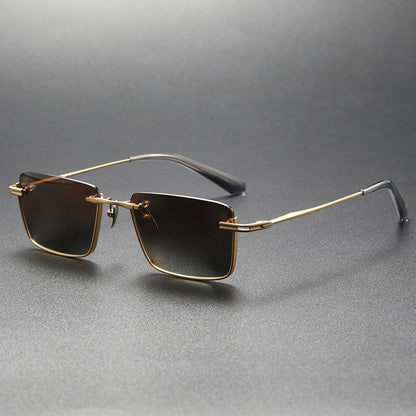 Black and gray polarized square sunglasses with gold metal frame and black temple tips on gray background