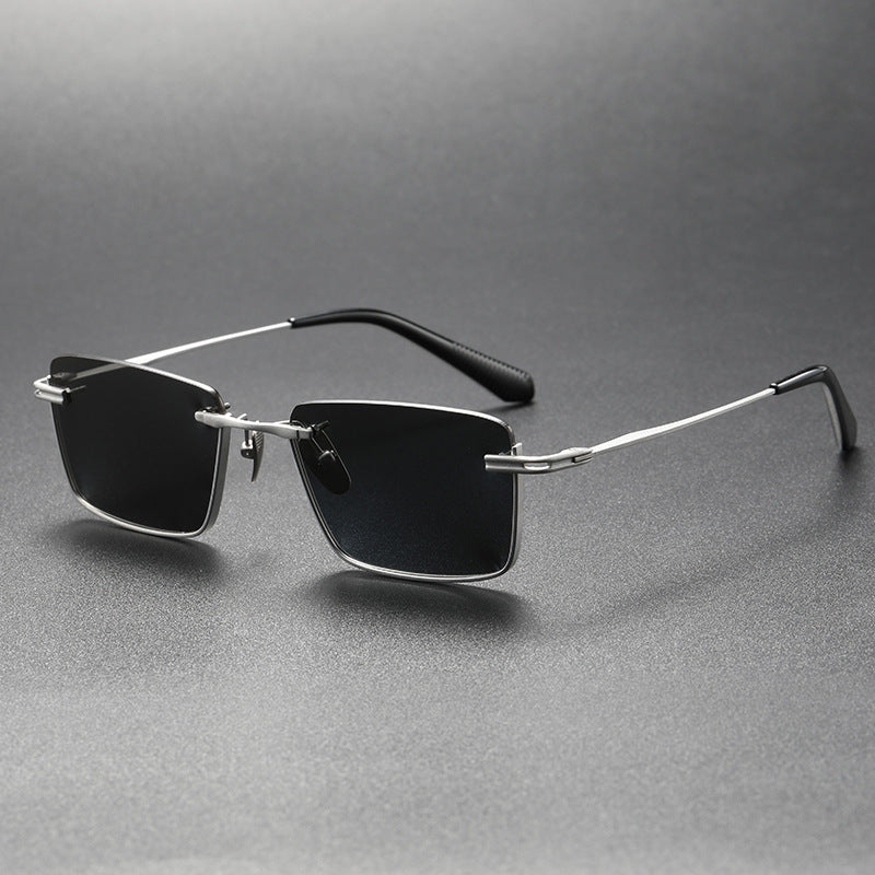 Retro style black and gray polarized sunglasses with rectangular lenses and metal frame on gray background
