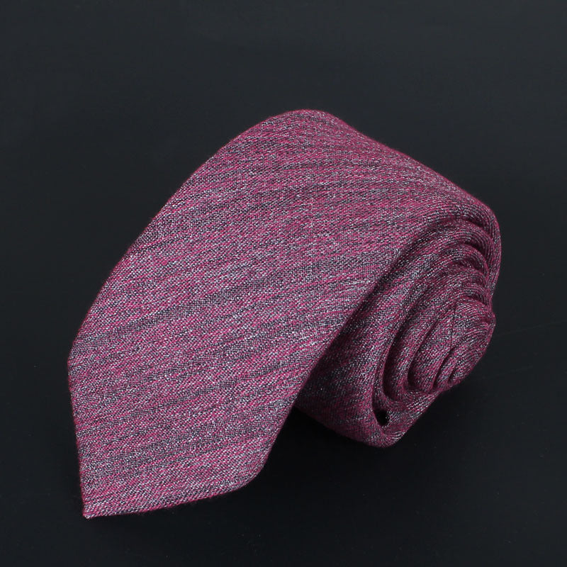 Rolled slim cotton tie in textured burgundy and gray shades on black background