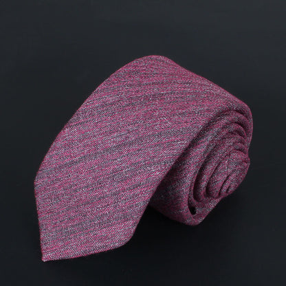 Rolled slim cotton tie in textured burgundy and gray shades on black background