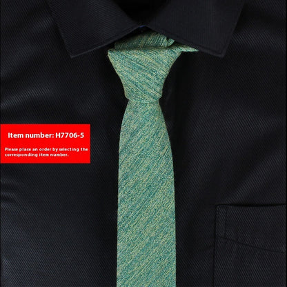 Green narrow cotton slim tie worn with black dress shirt for business casual and weddings