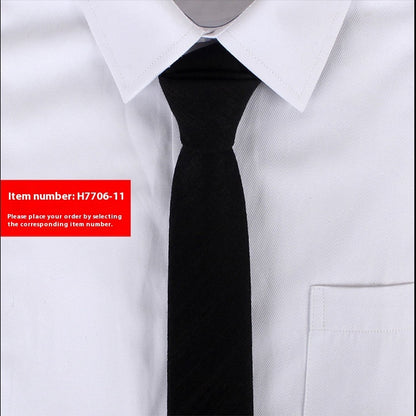 Black slim cotton tie on white dress shirt with pointed collar and chest pocket