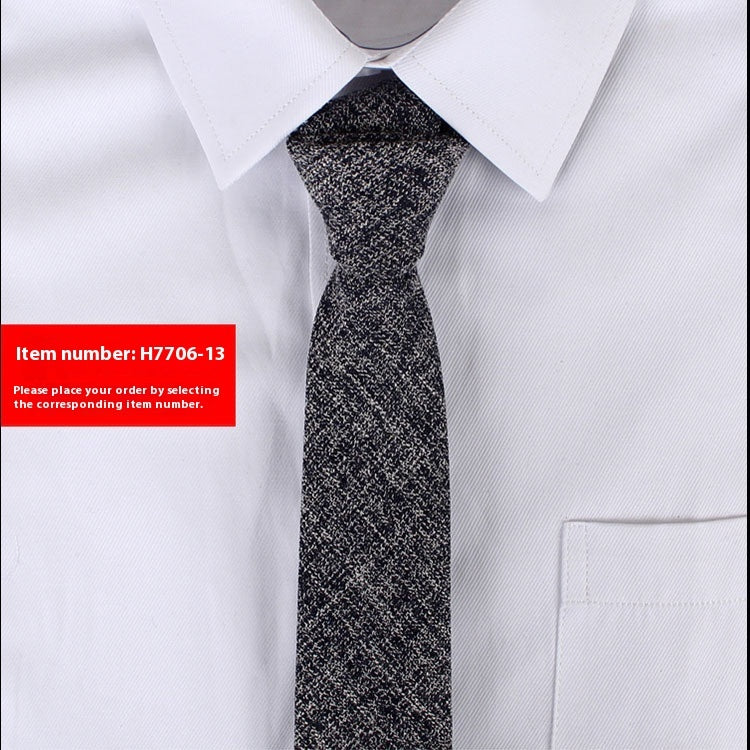 Slim black and white textured cotton tie paired with crisp white dress shirt, suitable for business or casual wear