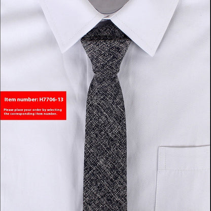 Slim black and white textured cotton tie paired with crisp white dress shirt, suitable for business or casual wear