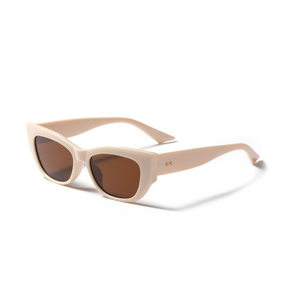 Retro British style sunglasses with cream thick frames and brown lenses on white background