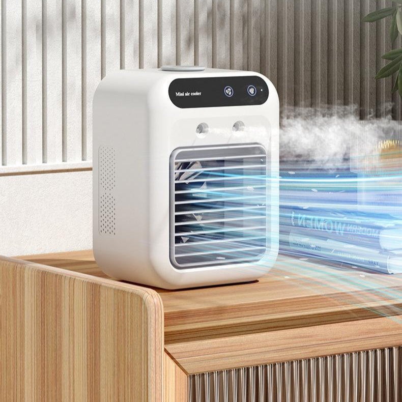Compact ivory white mini air cooler on wooden table emitting cool air and mist in modern room