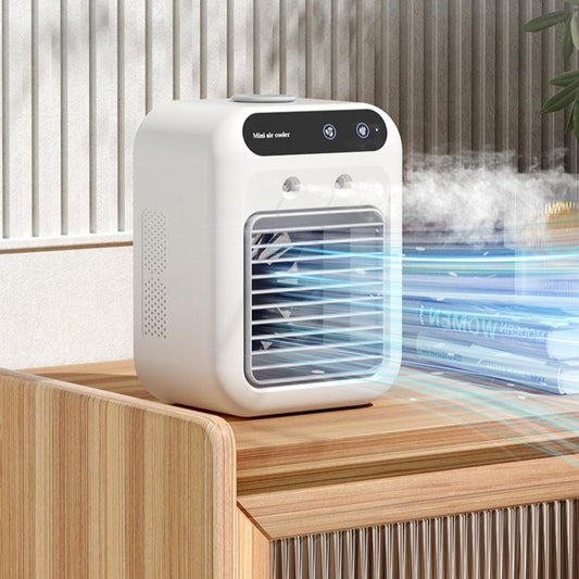 Compact ivory white mini air cooler on wooden table emitting cool air and mist in modern room
