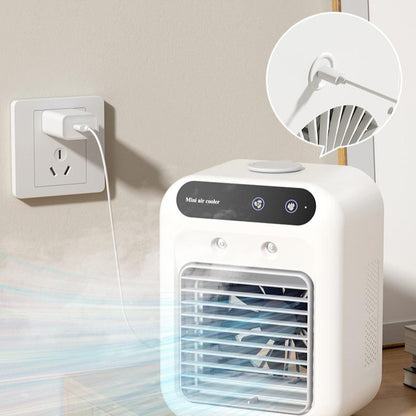 Ivory white mini air cooler on desk plugged into wall outlet with USB power cable