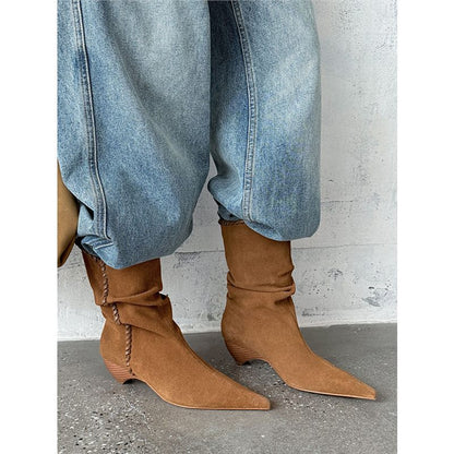 Brown suede pointed toe western boots with slouchy design worn with light blue jeans