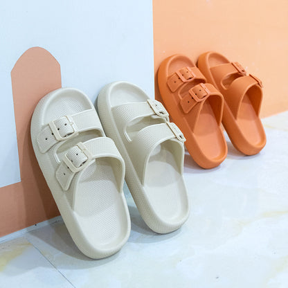 Pair of khaki and pair of orange thick-soled EVA sandals with double buckle straps on light floor