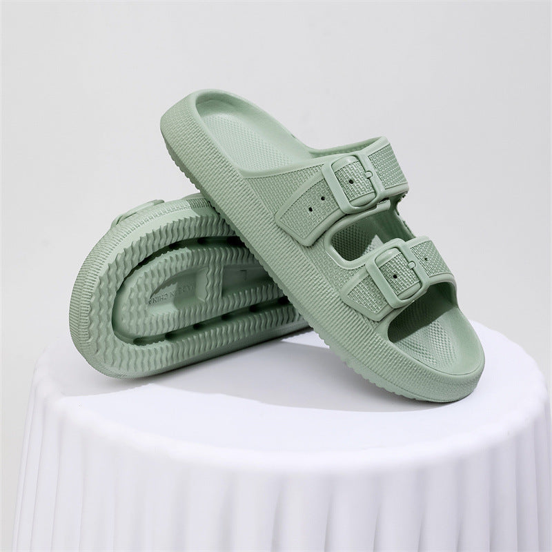 Pair of light green thick-soled EVA sandals with adjustable double buckle straps on white surface