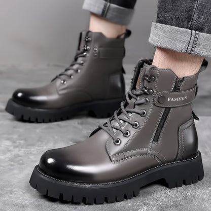 Men's gray leather lace-up boots with thick black soles and zipper detail worn with rolled gray jeans