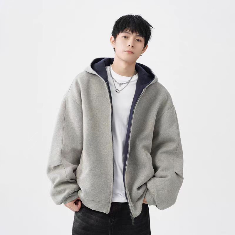 young man wearing light gray hooded sweater jacket with double zipper and navy inner lining, styled with white t-shirt and black pants