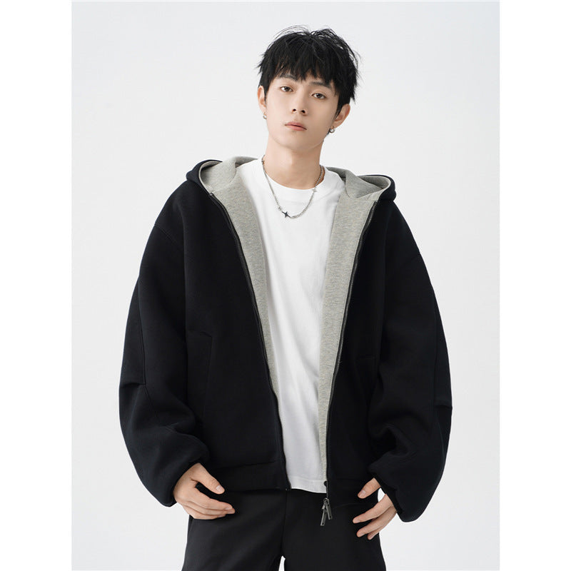 young man wearing black oversized hooded jacket with gray inner lining and white T-shirt