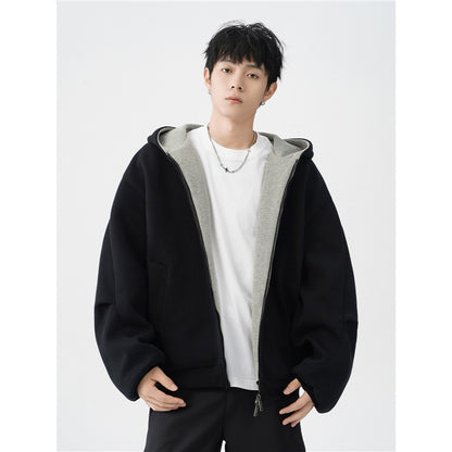 young man wearing black oversized hooded jacket with gray inner lining and white T-shirt
