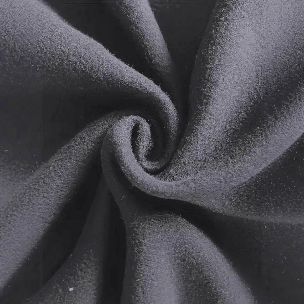 Close-up of soft, light gray fleece fabric with fuzzy texture, emphasizing warmth and comfort