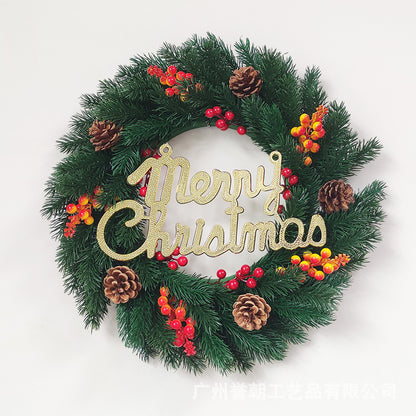 Christmas wreath with green pine branches, red and yellow berries, pinecones, and gold Merry Christmas sign