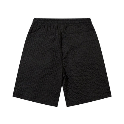 Black men's loose workwear shorts with textured polyester-cotton blend fabric and elastic waistband
