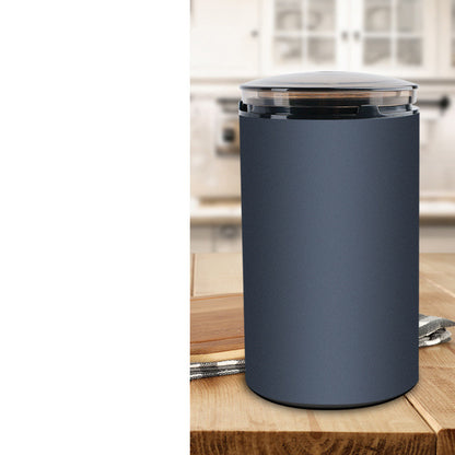 Navy blue electric herb grinder with aluminum alloy body on wooden kitchen table