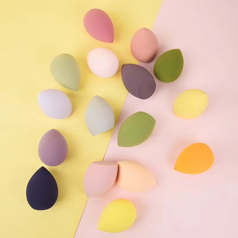 Set of colorful makeup sponges isolated on a yellow and pink background, makeup beauty blenders